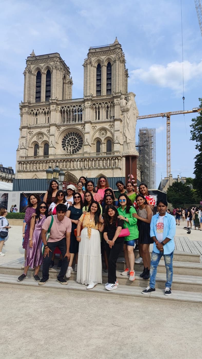 The student group in front of Notre-Dame de Paris, its twin towers behind them